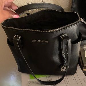 Handle is shedding MK purse